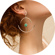 Gold hoop earring with emerald.