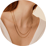 two layered, delicate gold necklaces