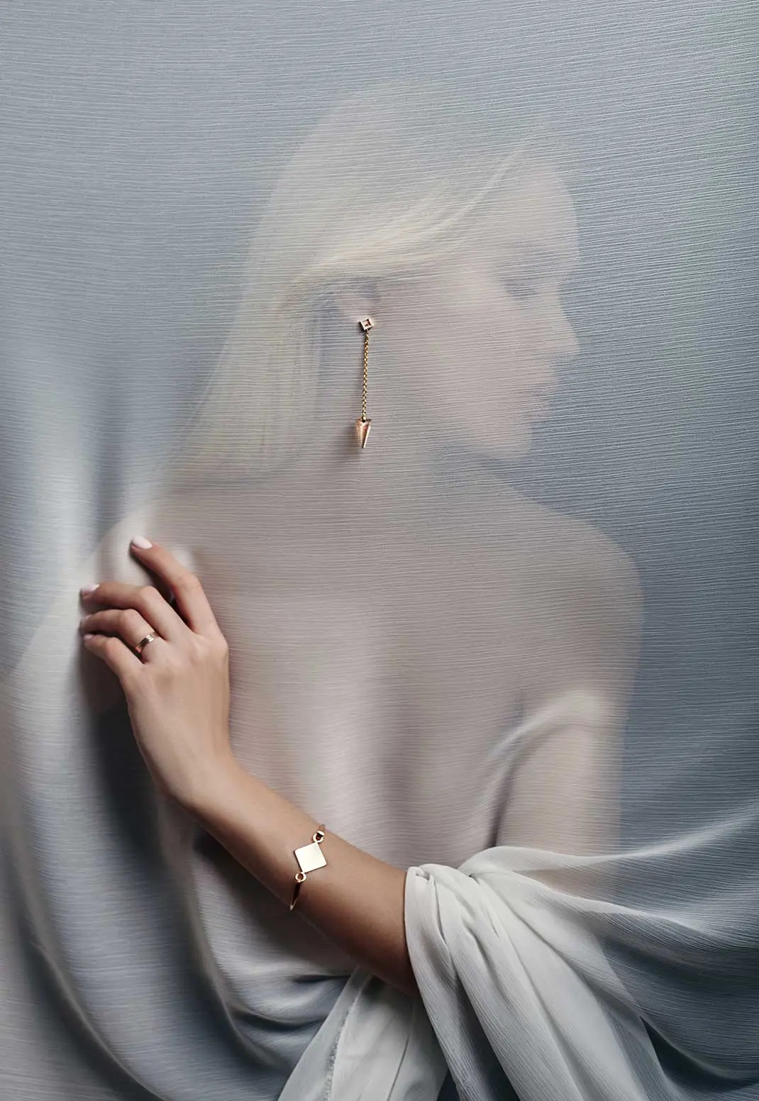 gold drop earring with a conical pendant