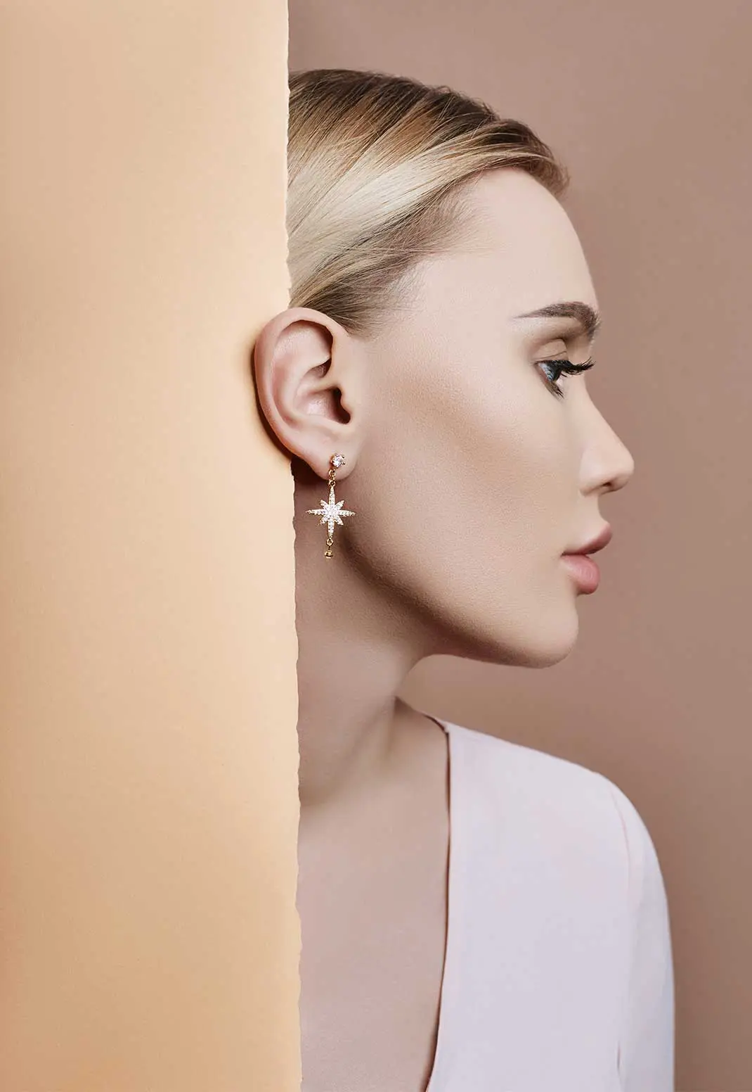 Woman wearing star-shaped earring.